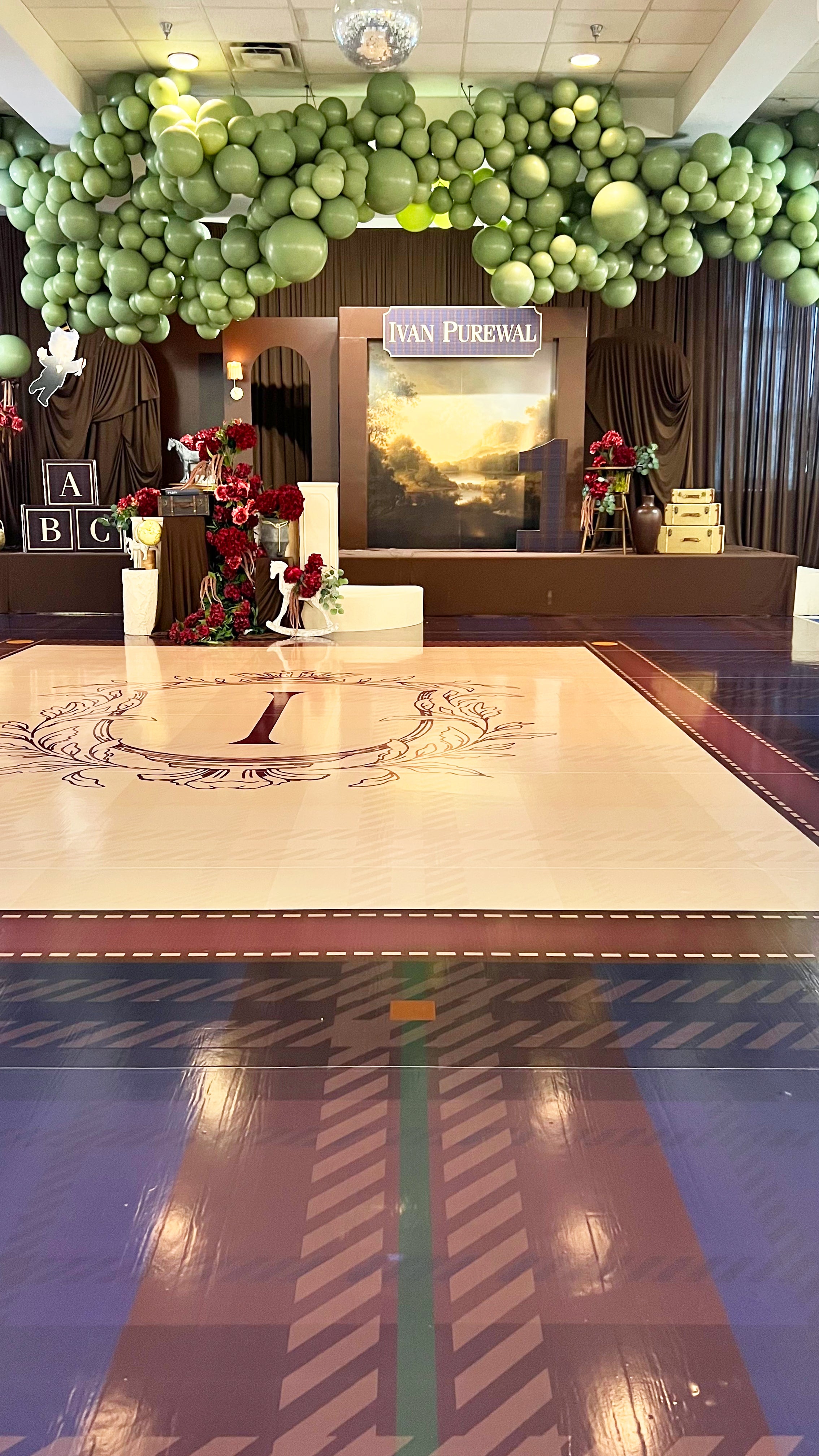 A grand-scale bespoke floor wrap and walkway by Heirloom Stationery. This immersive event design features intricate patterns and custom branding, transforming the venue floor into a stunning visual centerpiece.