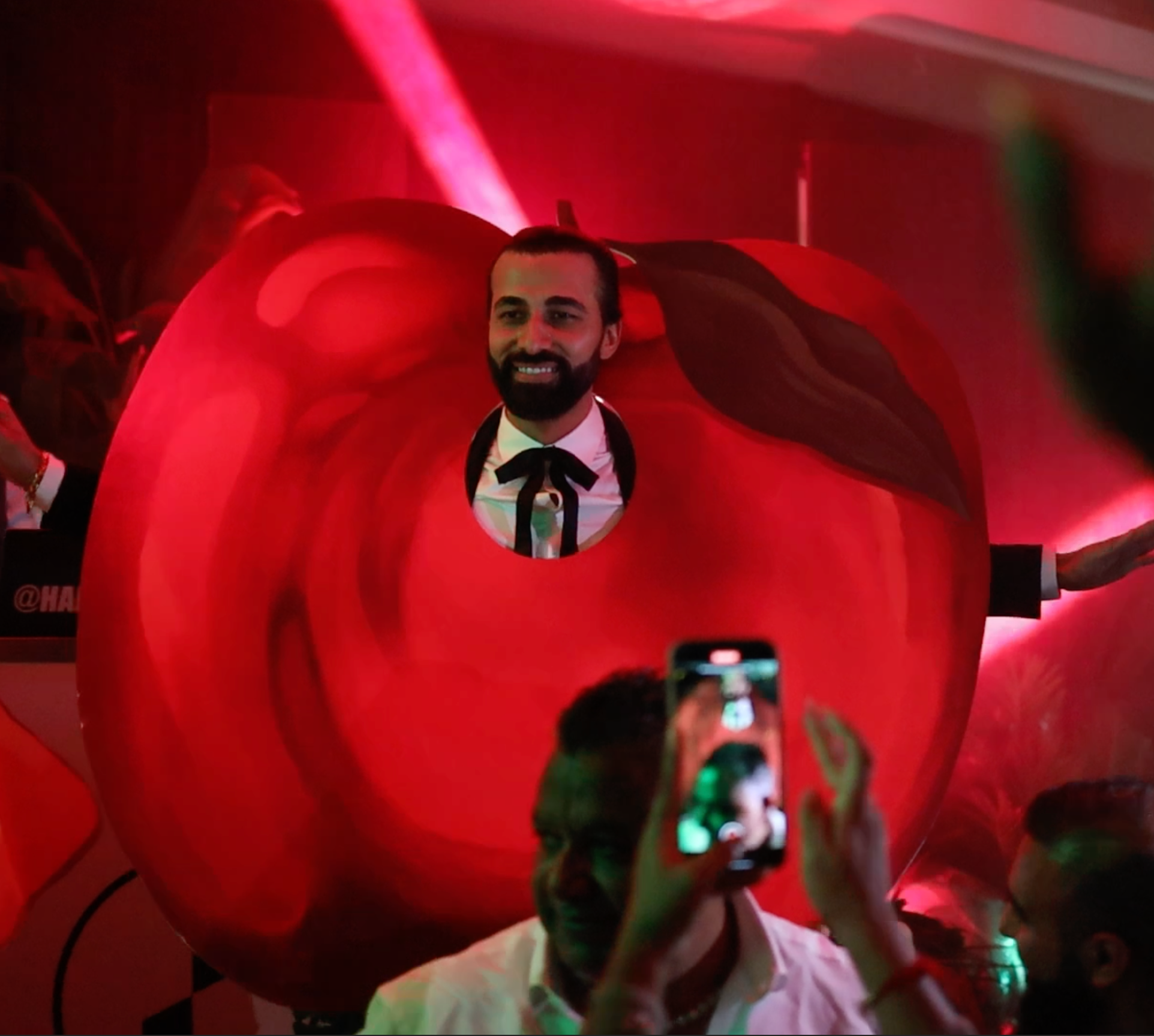 A bespoke custom-shape cut-out in a vibrant apple silhouette. Heirloom Stationery creates precision-cut event props and wearable costumes tailored to any theme, providing a playful and interactive element for modern celebrations.