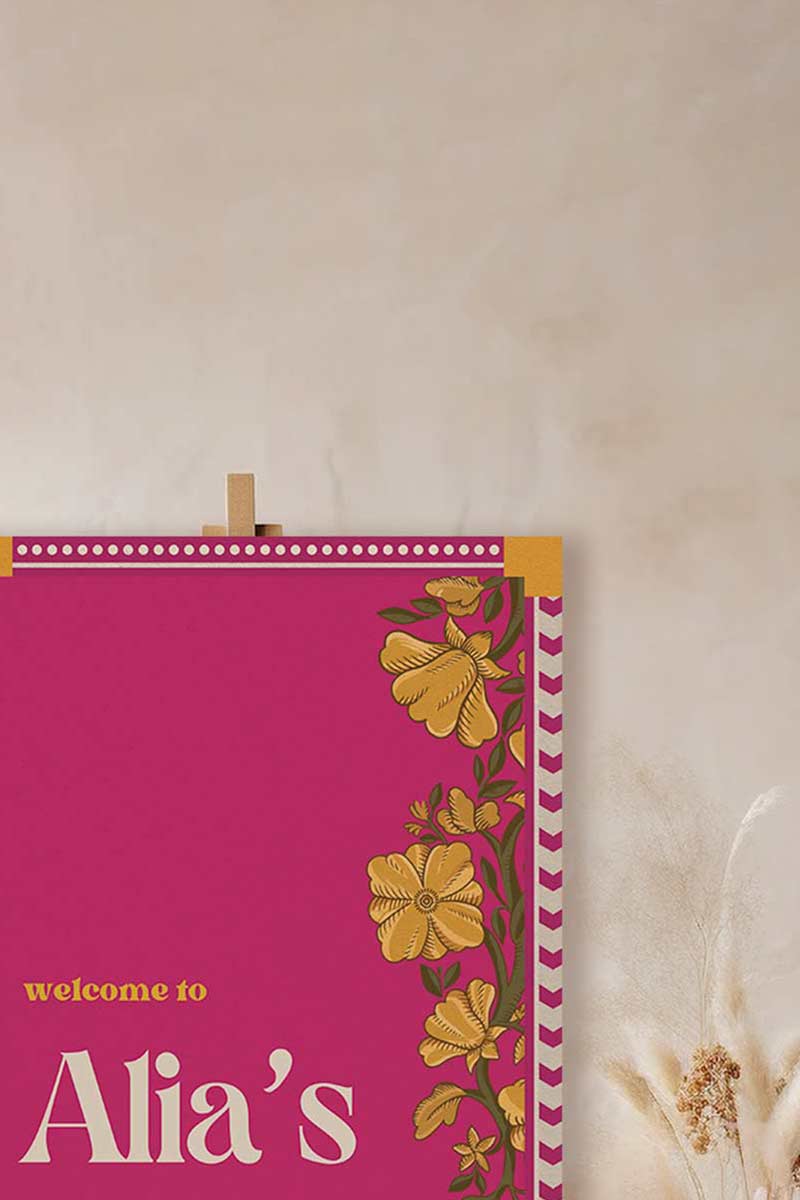 Retro Wedding Welcome Sign with florals in the shades of hot pink, yellow, and beige. Indian Wedding Events like jago, sangeet, mehndi, haldi, chunni & maiyan. Personalize and customize in Canva. Print at any local printer around the World.