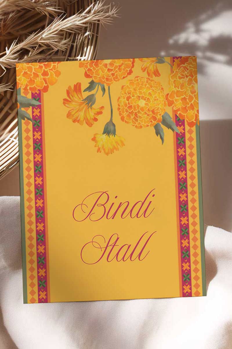 Wedding Stationery Sign with marigold florals in the shades of yellow, orange & green phulkari. Bangle Station, Bindi Bar, Jhumka Bar, Mehndi Station, Chai Station. Personalize and customize in Canva. Print at any local printer around the World.