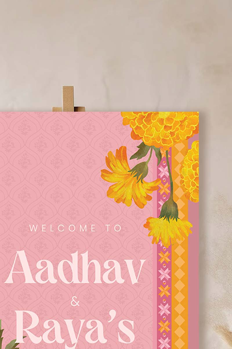 Orange, yellow & soft pink retro Wedding Welcome Sign with orange & yellow marigold florals. Pink roses. Tradiitonal Indian wedding sign. Indian Wedding events for Sangeet, Haldi, Maiyan or Jago. Wedding Signage. Personalize and customize in Canva. Digital Download.  Print around the world at a local print shop.