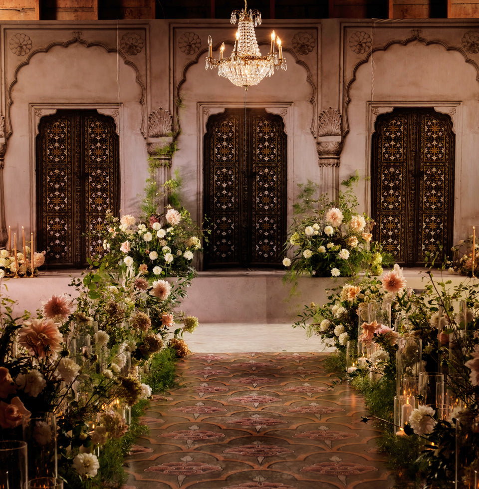 A bespoke printed event backdrop featuring a Jaipur-inspired palace doorway design. This architectural heritage artwork by Heirloom Stationery creates a regal and immersive setting for grand wedding celebrations.